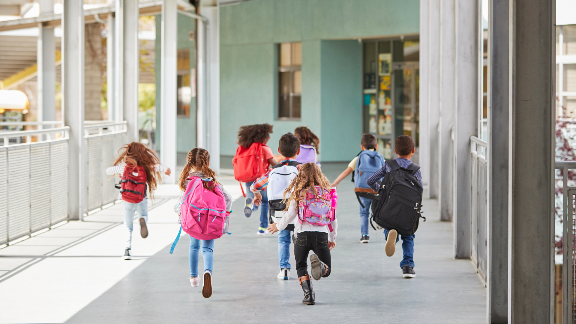 K-12 kids running into school.